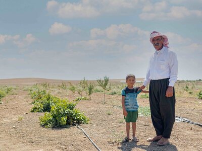 Photo: WFP Mukhtar from Sinjar in Ninawa governorate with his son at the orchard under rehabilitation with WFP's support.