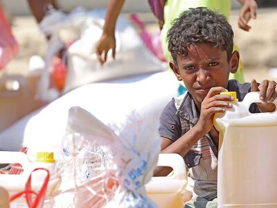 Photo: WFP/Ammar Bamatraf Boy with food items distributed by WFP due to the high levels of food insecurity and malnutrition in Yemen