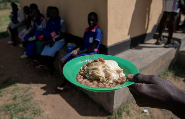 A closeup a green plastic bowl containing a WFP school meal: a hearty porridge and beans. Photo: WFP/Alessandro Abbonizio
