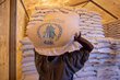 A worker carries WFP food bags in South Sudan, where funding cuts are shrinking food aid. Photo: WFP/Samantha Reinders