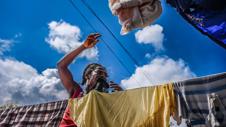 A woman hangs up laundry in Port-au-Prince, Haiti. Photo: WFP/Luc Junior Segur