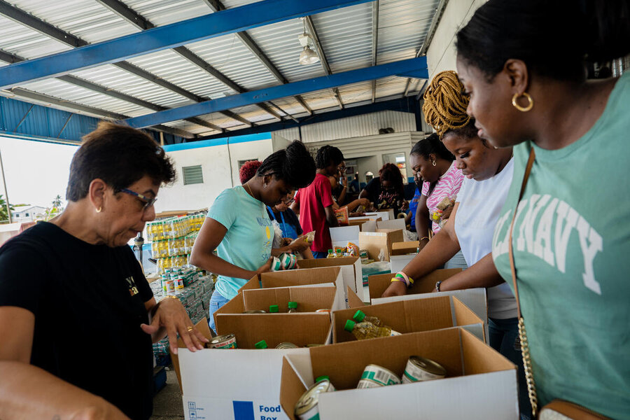 People packing WFP food boxes in Barbados