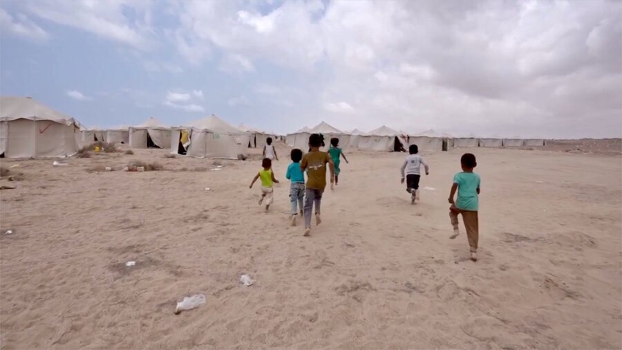 Children play pickup football at a sandy displacement camp in Aden, Yemen. Photo: WFP