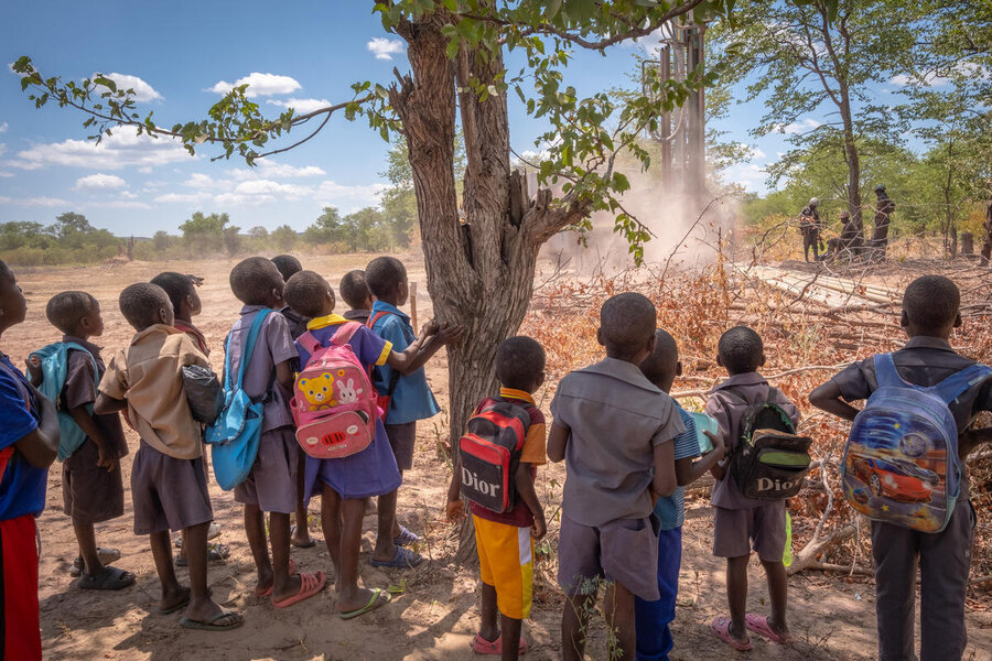 A crowd of children watch the construction of a WFP-supported project to bring water to a parched community in Zimbabwe in 2024. Photo: WFP/KB Mpofu 